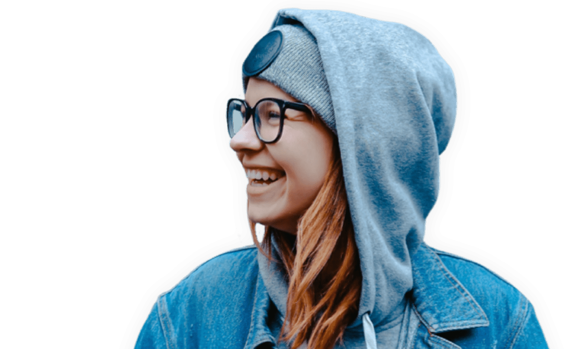 girl in blue jacket and glasses smiling 
