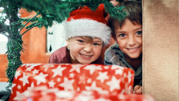 young kids excited to open holiday gifts