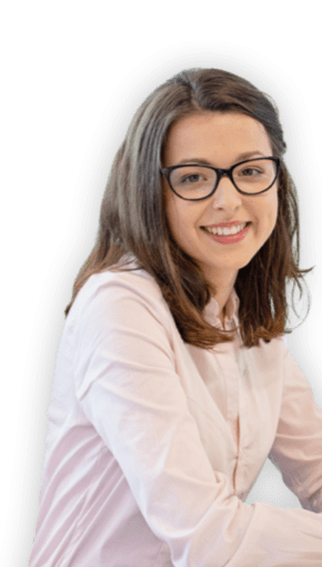 women in pink blouse and glasses smiling