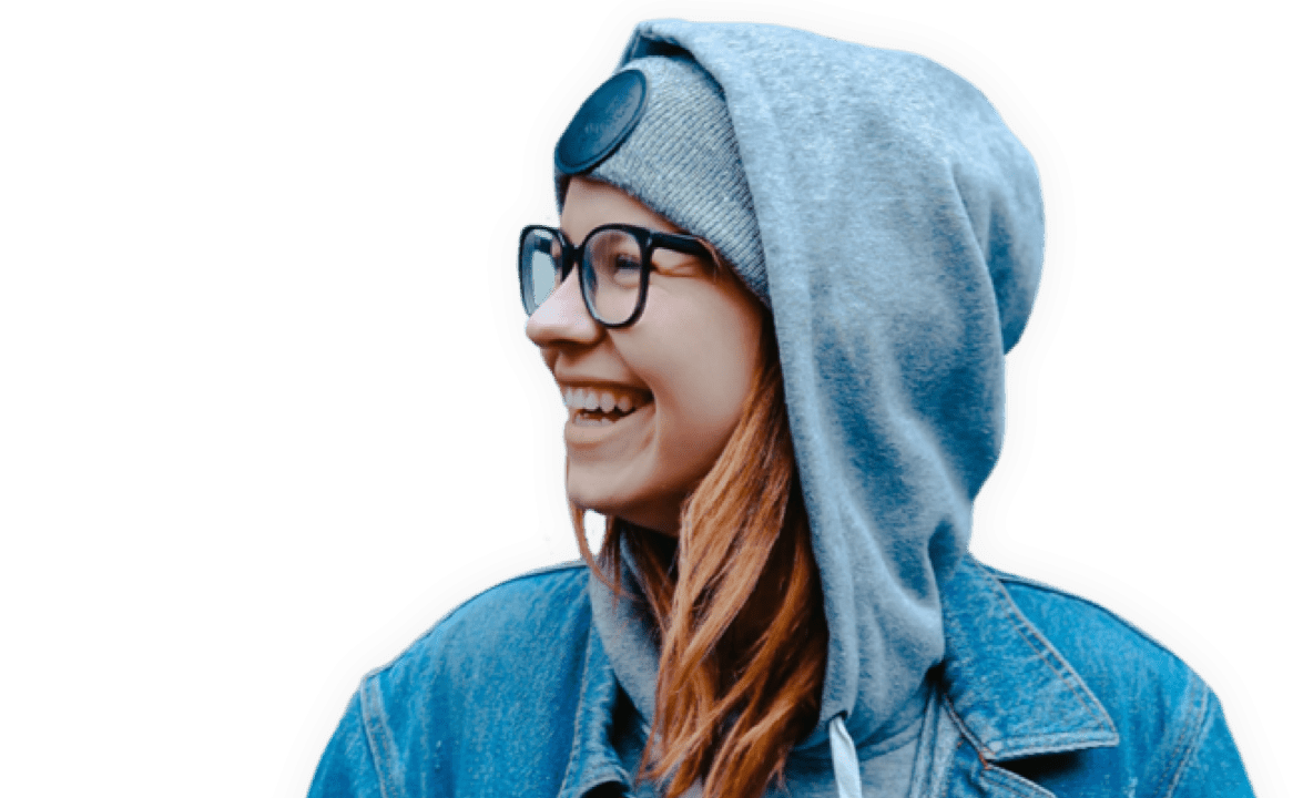 girl in blue jacket and glasses smiling